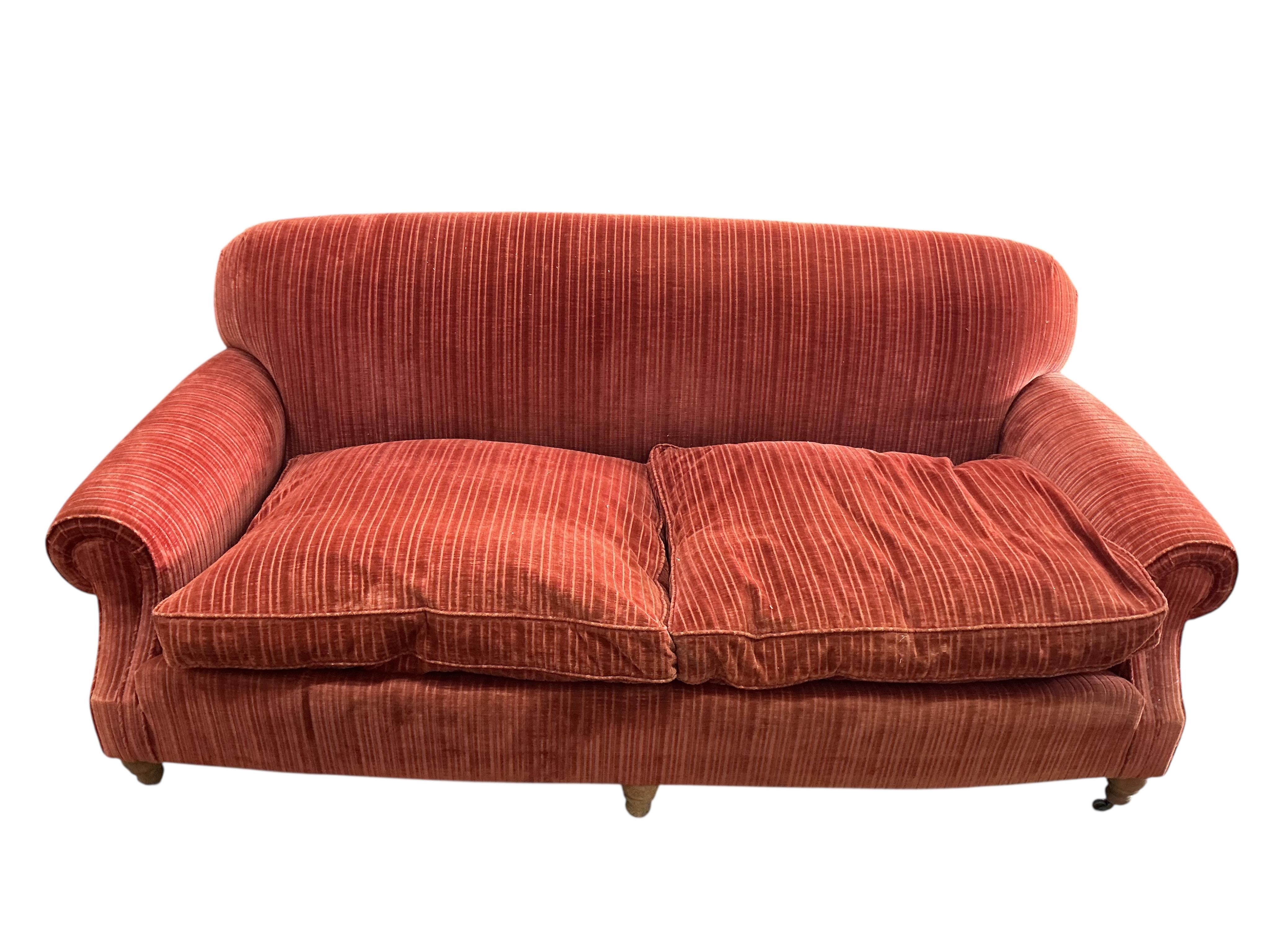 A modern Howard style upholstered two seater settee, width 206cm, depth 92cm, height 84cm, Provenance: The late Kenneth Turner (1936-2025), celebrity florist, designer and perfume retailer, he received the Royal Warrant